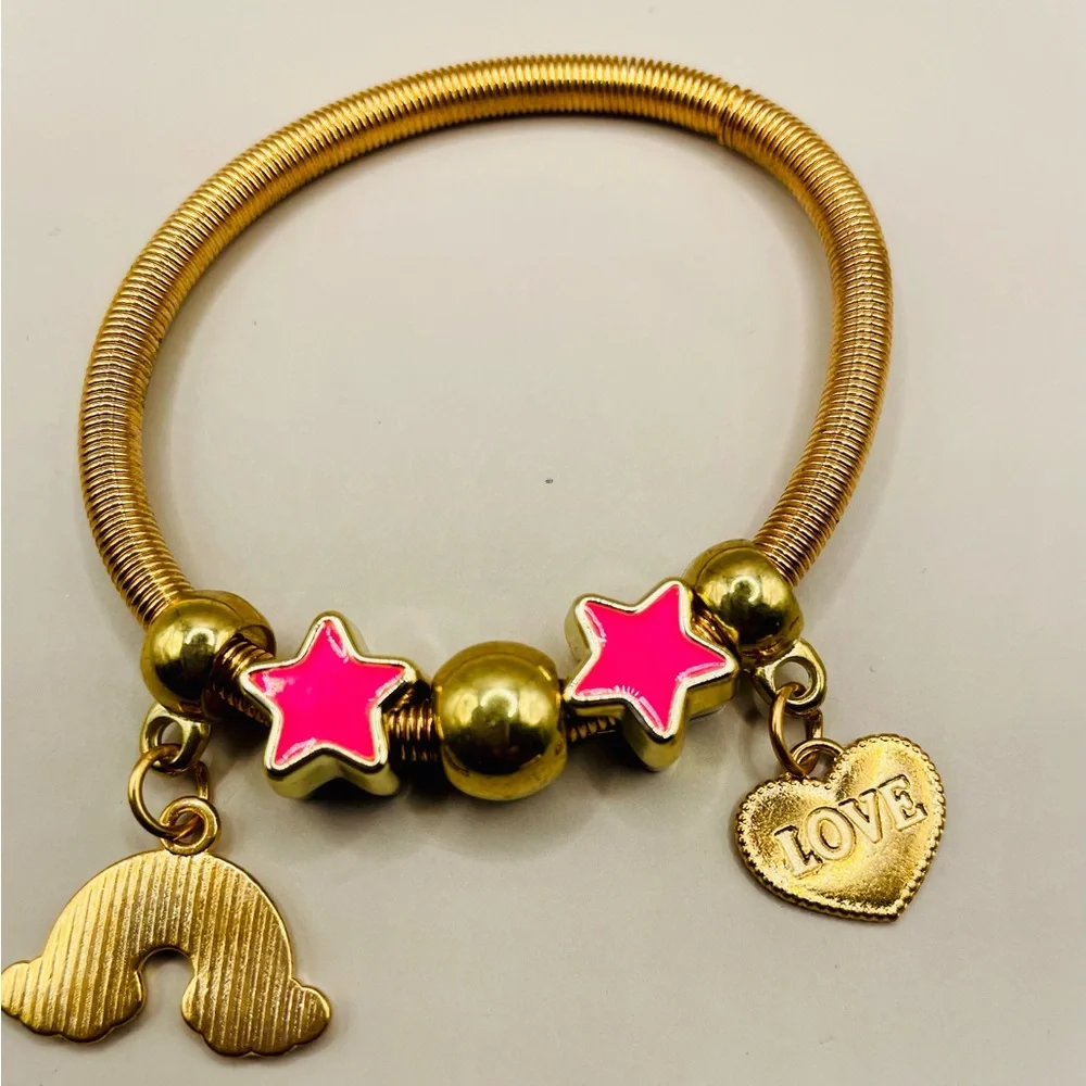 Yellow gold plated spring baby bangle with rainbow, heart and star charms.